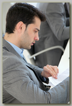 Business man reading over several documents